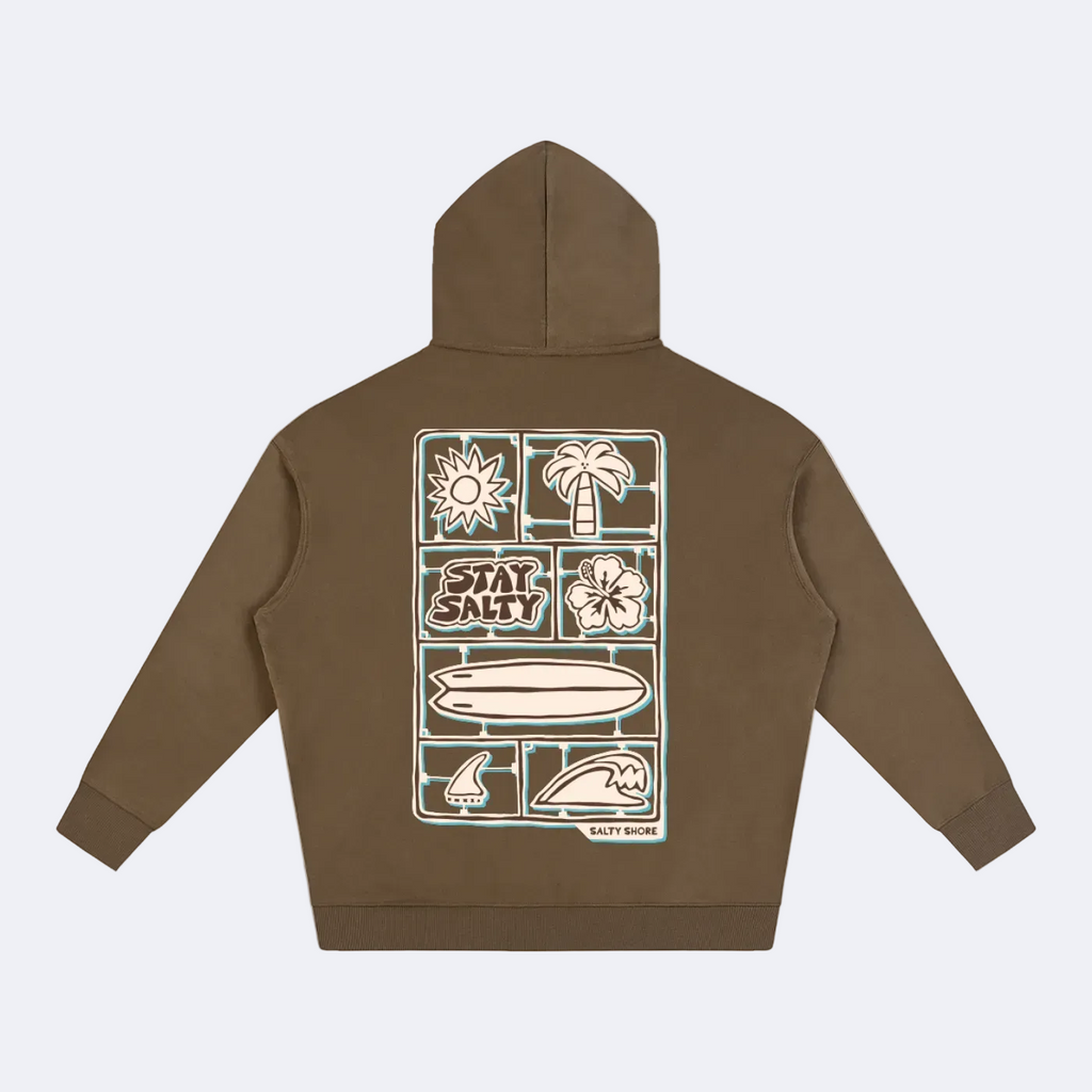A brown pullover hoodie shown from the back, featuring a large rectangular graphic print with surf-themed illustrations and the words 'STAY SALTY' in the center.
