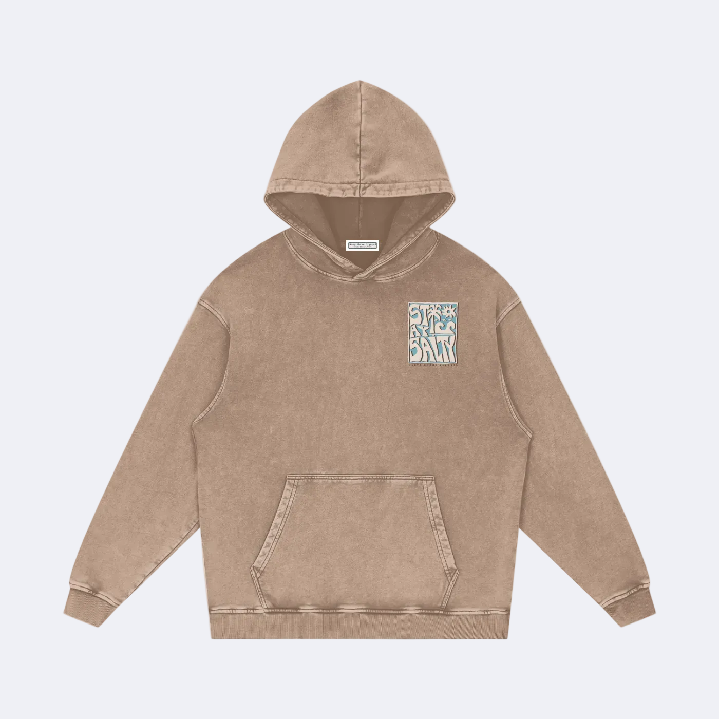 A washed brownish-beige pullover hoodie with a small square graphic patch on the left chest, displayed flat against a solid white background.