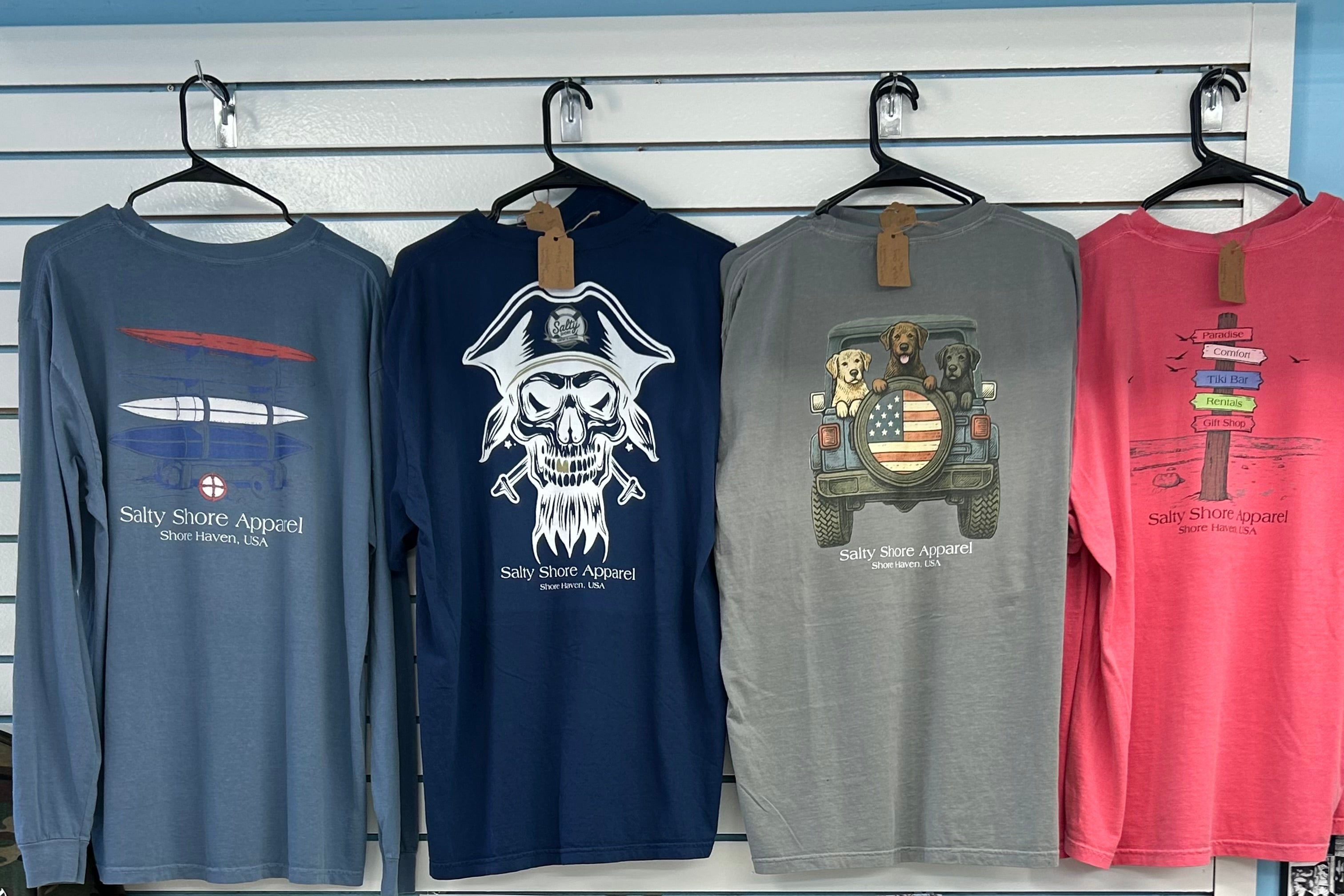 Collection of Salty Shore apparel on display with a QR code poster in the background.