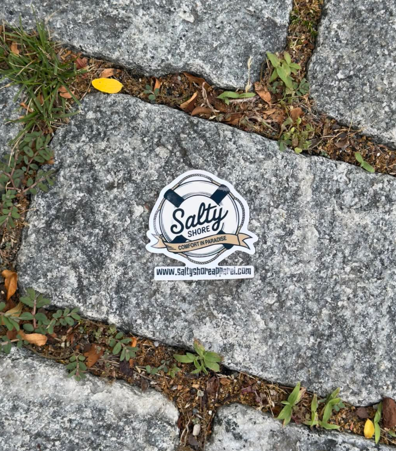 A screenshot of a computer browser showing an Instagram post about a custom car sticker. The post features a square photo of a gray stone pavement with a white circular sticker that reads 'Salty' and 'www.